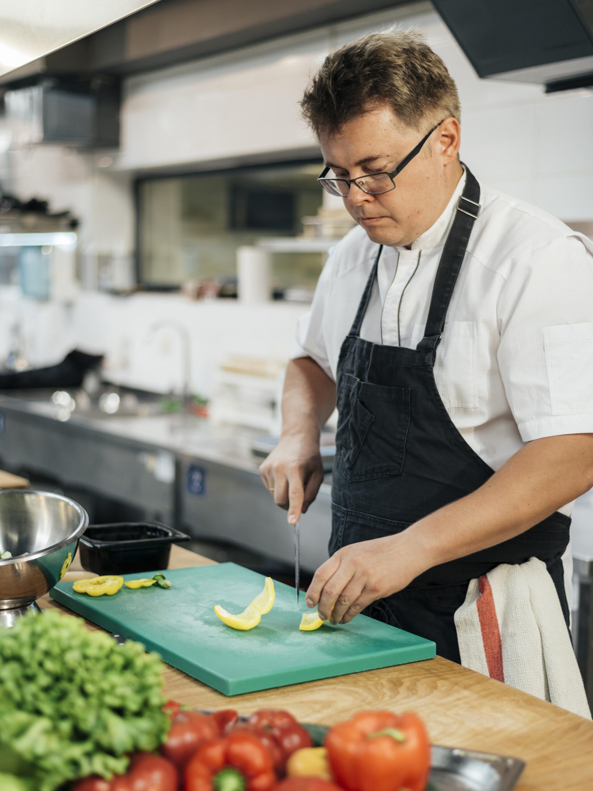 Chef cutting vegetables with a freshly sharpened knife